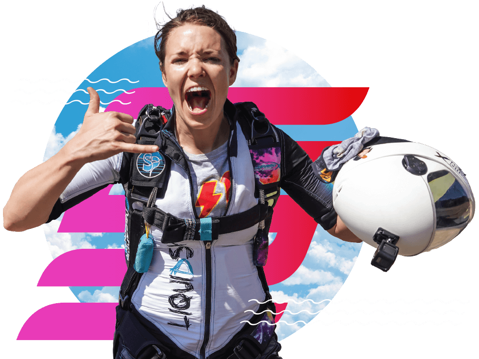 Licensed female skydiver holding her helmet and giving a rock on sign